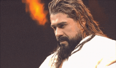 A Man With Long Hair And A Beard Is Wearing A White Towel GIF