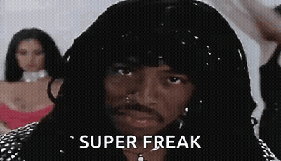 A Man With Long Hair And A Beard Is Wearing A Wig And Earrings And Says `` Super Freak '' . GIF