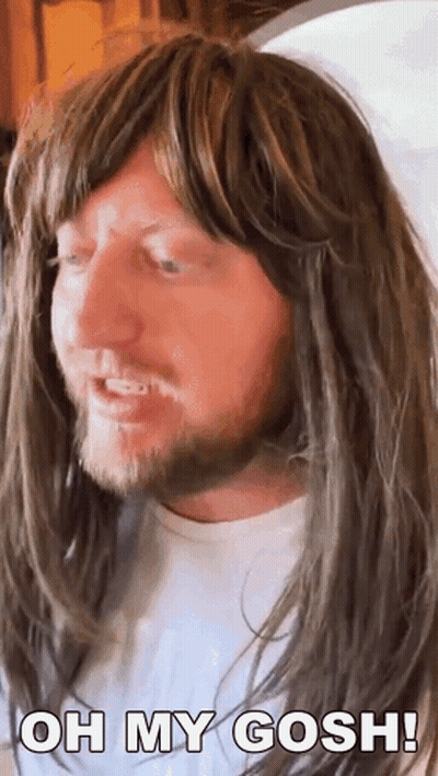 A Man With Long Hair And A Beard Is Wearing A Wig And Says Oh My Gosh ! GIF