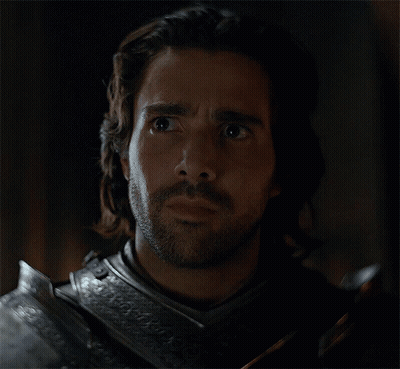 A Man With Long Hair And A Beard Is Wearing Armor And Looking Surprised GIF