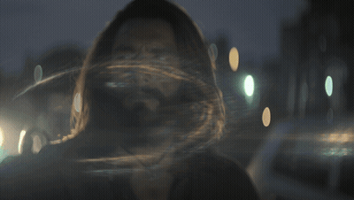 A Man With Long Hair And A Beard Looks At Something GIF