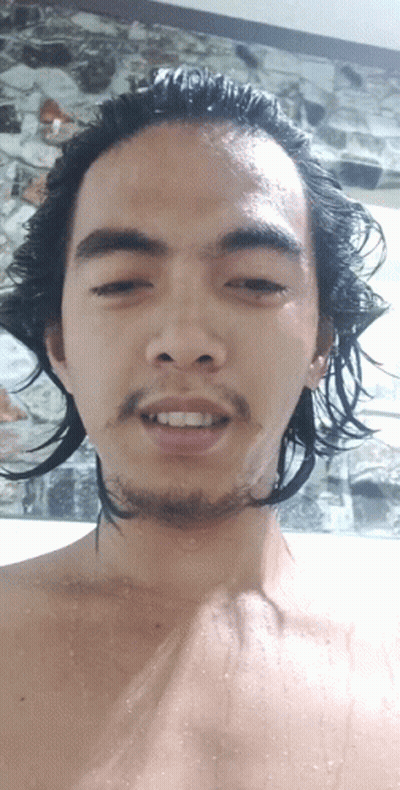 A Man With Long Hair And A Beard Looks At The Camera With His Eyes Closed GIF