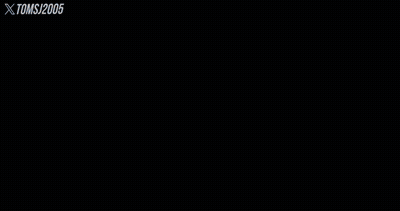 A Man With Long Hair And A Beard Looks At The Camera With Xtomsj2005 Written On The Bottom Right GIF