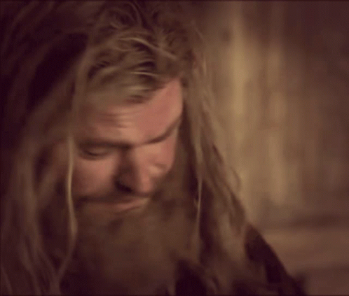 A Man With Long Hair And A Beard Making A Face GIF