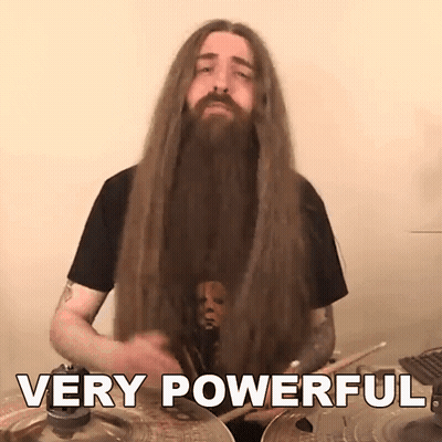 A Man With Long Hair And A Beard Playing Drums With The Words Very Powerful Behind Him GIF