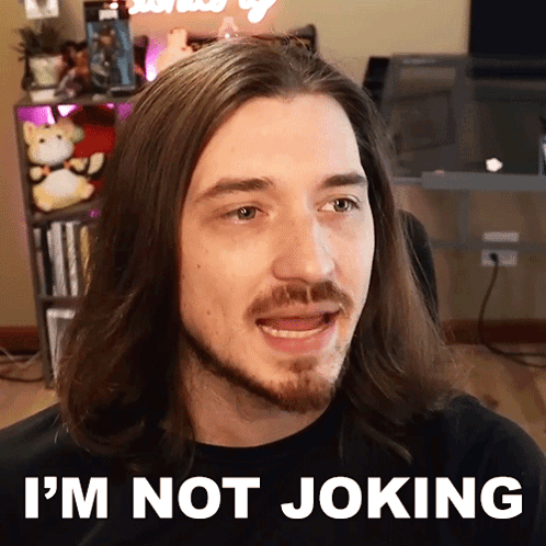 A Man With Long Hair And A Beard Says " I 'M Not Joking " In Front Of His Face GIF