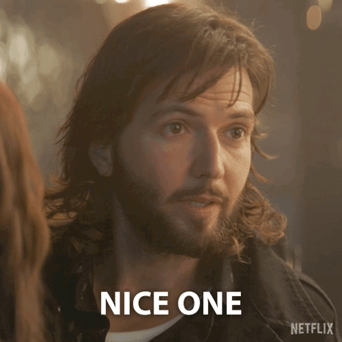 A Man With Long Hair And A Beard Says Nice One In Front Of A Netflix Logo GIF