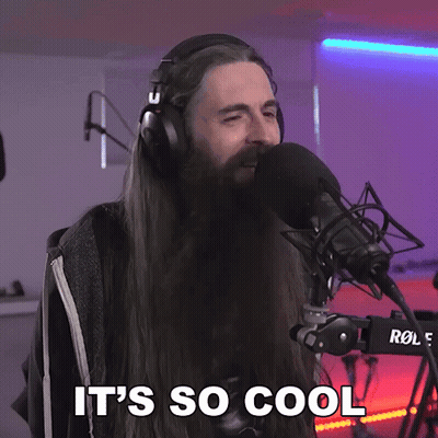 A Man With Long Hair And A Beard Singing Into A Microphone With The Words It 'S So Cool Above Him GIF