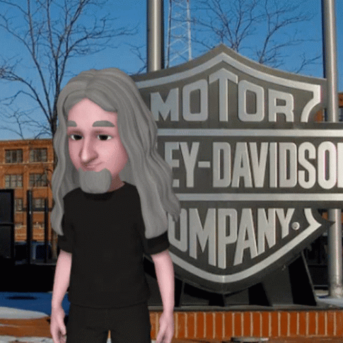 A Man With Long Hair And A Beard Stands In Front Of A Harley Davidson Company Sign GIF