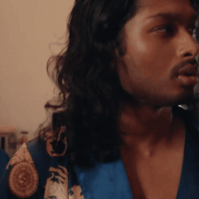 A Man With Long Hair And A Beard Wearing A Blue Robe GIF