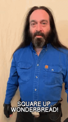 A Man With Long Hair And A Beard Wearing A Blue Shirt Says Square Up Wonderbread GIF
