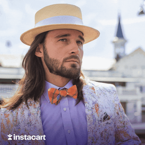 A Man With Long Hair And A Beard Wearing A Hat And Bow Tie With Instacart In The Corner GIF