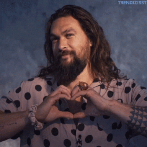 A Man With Long Hair And A Beard Wearing A Polka Dot Shirt With The Word Trendizsst On The Bottom GIF