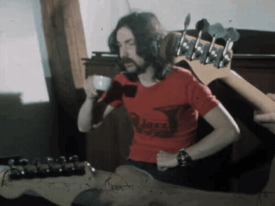 A Man With Long Hair And A Beard Wearing A Red Shirt That Says ' Jazz ' On It GIF