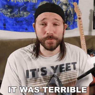 A Man With Long Hair And A Beard Wearing A Shirt That Says It 'S Yeet GIF