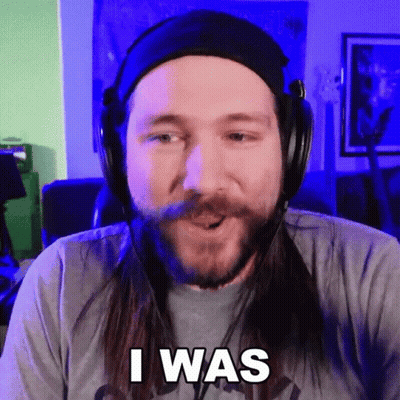 A Man With Long Hair And A Beard Wearing Headphones Says " I Was " GIF
