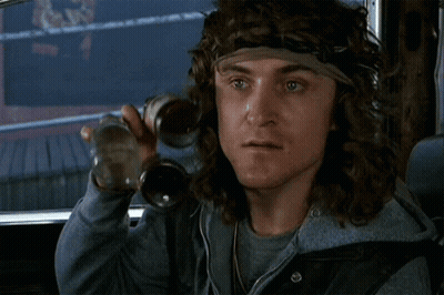 A Man With Long Hair And A Headband Is Holding A Bottle GIF