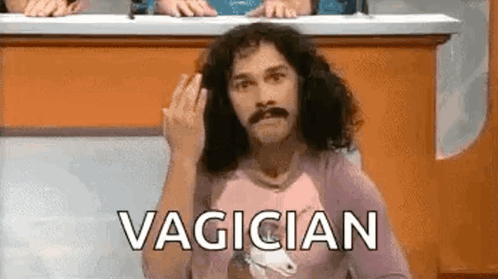 A Man With Long Hair And A Mustache Is Giving The Middle Finger While Sitting At A Table . GIF