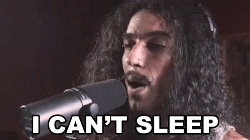 A Man With Long Hair And A Mustache Is Singing Into A Microphone And Saying `` I Can 'T Sleep '' . GIF
