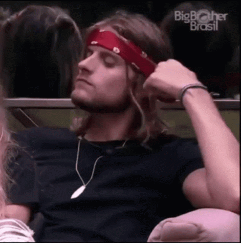 Man With Long Hair And Red Headband Sitting GIF