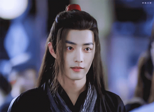 A Man With Long Hair And A Red Ponytail GIF