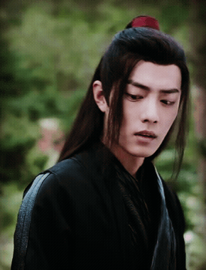 A Man With Long Hair And A Red Ponytail GIF