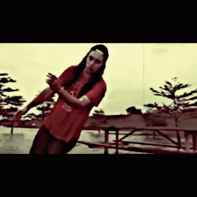 A Man With Long Hair And A Red Shirt That Says Coca Cola On It GIF