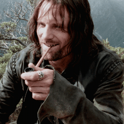 A Man With Long Hair And A Ring On His Finger Smoking A Pipe GIF