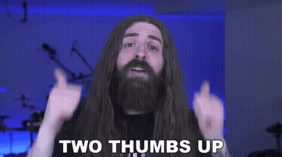 A Man With Long Hair Is Giving Two Thumbs Up GIF