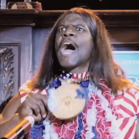 A Man With Long Hair Is Holding A Medal Around His Neck GIF