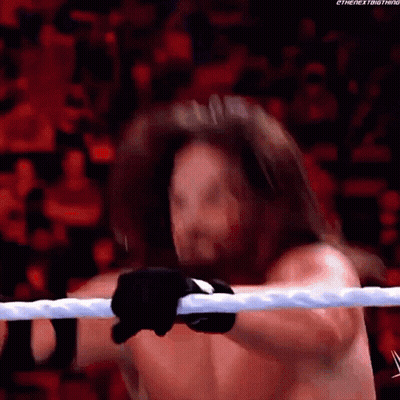 A Man With Long Hair Is Holding A Rope In A Wrestling Ring .. GIF