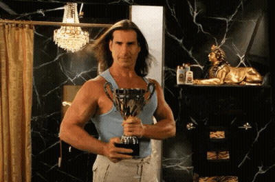 A Man With Long Hair Is Holding A Trophy In His Hand GIF