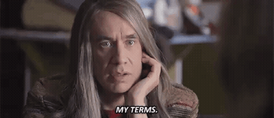 A Man With Long Hair Is Making A Funny Face And Says `` My Terms '' . GIF