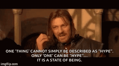 A Man With Long Hair Is Making A Funny Face While Talking About A State Of Being . GIF