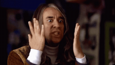 A Man With Long Hair Is Making A Funny Face With His Hands GIF