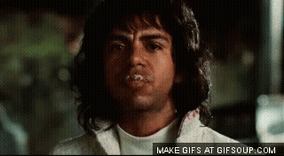 A Man With Long Hair Is Making A Funny Face With His Mouth Covered In Saliva . GIF
