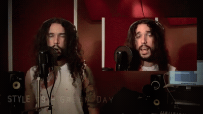 A Man With Long Hair Is Singing Into A Microphone With The Words Style # 10 Gregorian Chante Below Him GIF