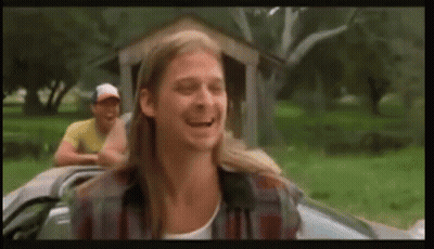 A Man With Long Hair Is Sitting In A Car With Another Man Behind Him . GIF