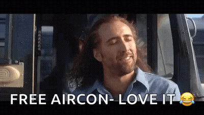 A Man With Long Hair Is Sitting In A Car With His Eyes Closed And Says `` Free Aircon - Love It '' . GIF