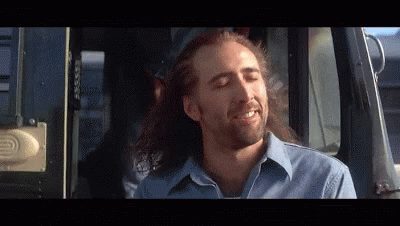 A Man With Long Hair Is Sitting In A Car With His Eyes Closed GIF