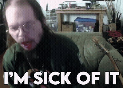 A Man With Long Hair Is Sitting On A Couch With The Words I 'M Sick Of It Behind Him GIF