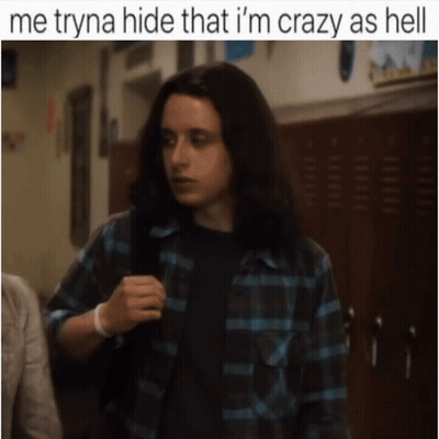 A Man With Long Hair Is Standing In A Hallway With The Caption Me Tryna Hide That I 'M Crazy As Hell . GIF
