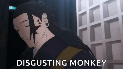 A Man With Long Hair Is Standing In Front Of A Building With The Words `` Disgusting Monkey '' Written Next To Him . GIF