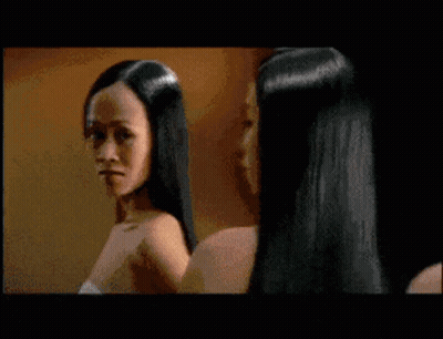 A Man With Long Hair Is Standing Next To Two Naked Women GIF