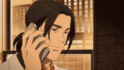 A Man With Long Hair Is Talking On A Phone GIF