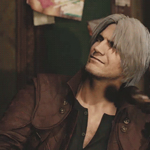 A Man With Long Hair Is Talking On A Phone GIF