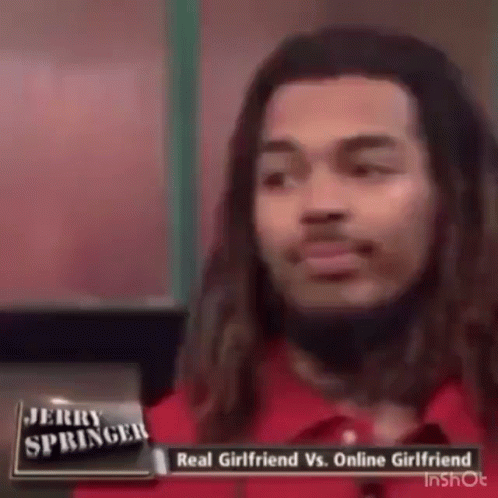 a man with long hair is talking on jerry springer 's show about a real girlfriend vs. online girlfriend .