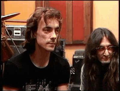 A Man With Long Hair Is Wearing A Black Shirt That Says ' I Love You ' On The Front GIF