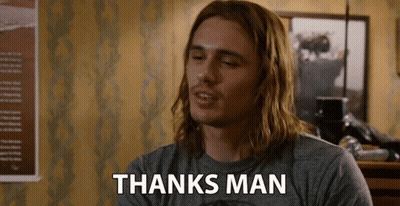 A Man With Long Hair Is Wearing A Gray Shirt That Says Thanks Man GIF