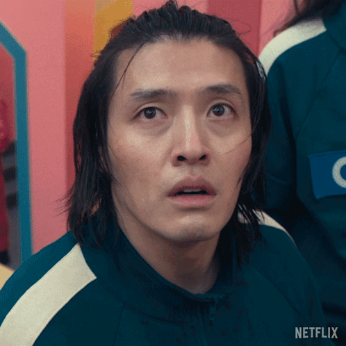 A Man With Long Hair Is Wearing A Green Netflix Uniform GIF